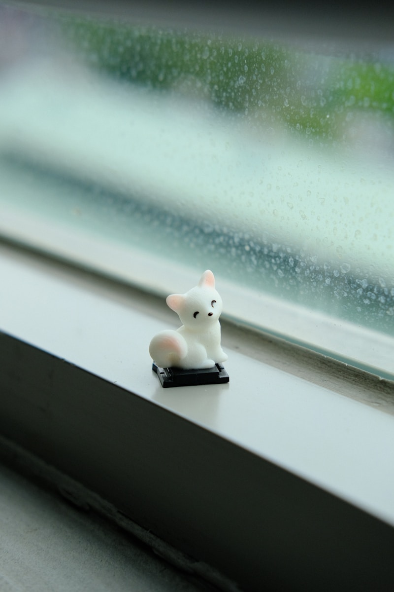 white cat figurine on white table